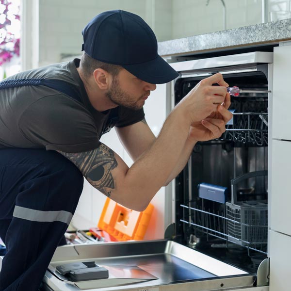 technician repairing dishwasher