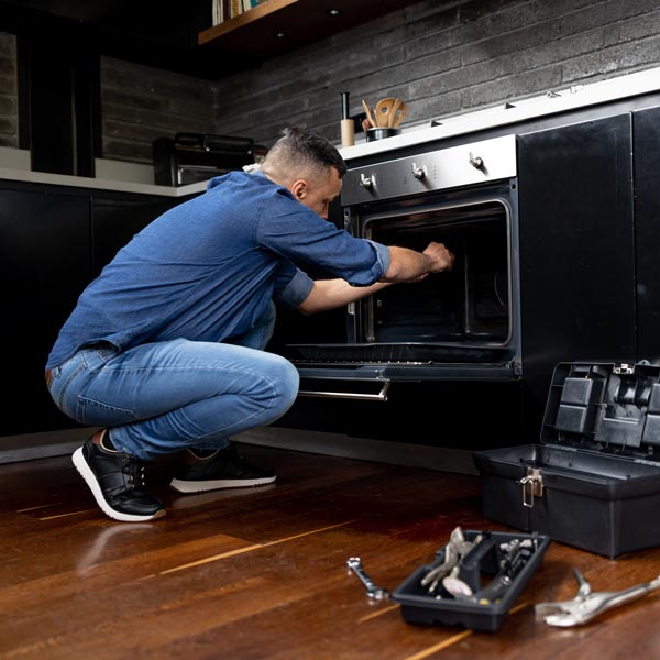 technician repairing oven