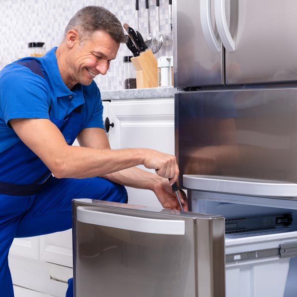 Technician Repairing a freezer for efficient operation in Salt Lake County, UT