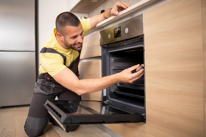 Technician Repairing a freezer for efficient operation in Salt Lake County, UT